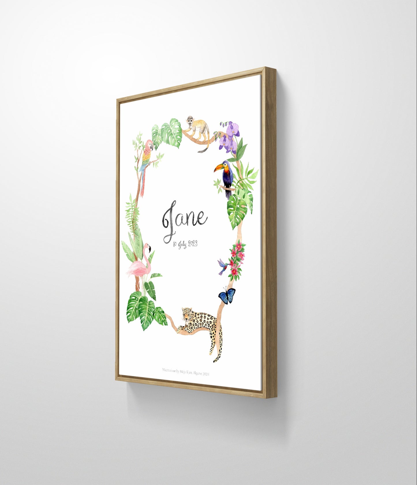 Jungle name poster in simple oak frame hanging on white wall side view