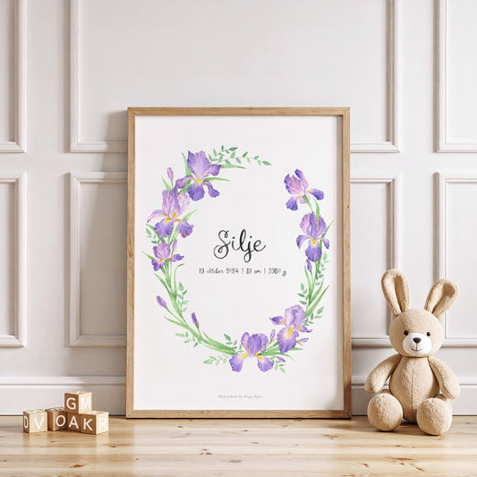 Framed floral print with a teddy bear and wooden blocks on a light wood floor.