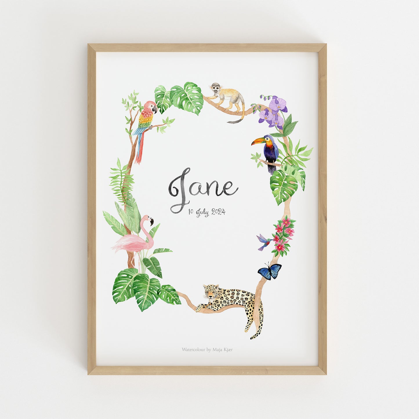 Framed baby name poster with jungle animals and leaves on a white background