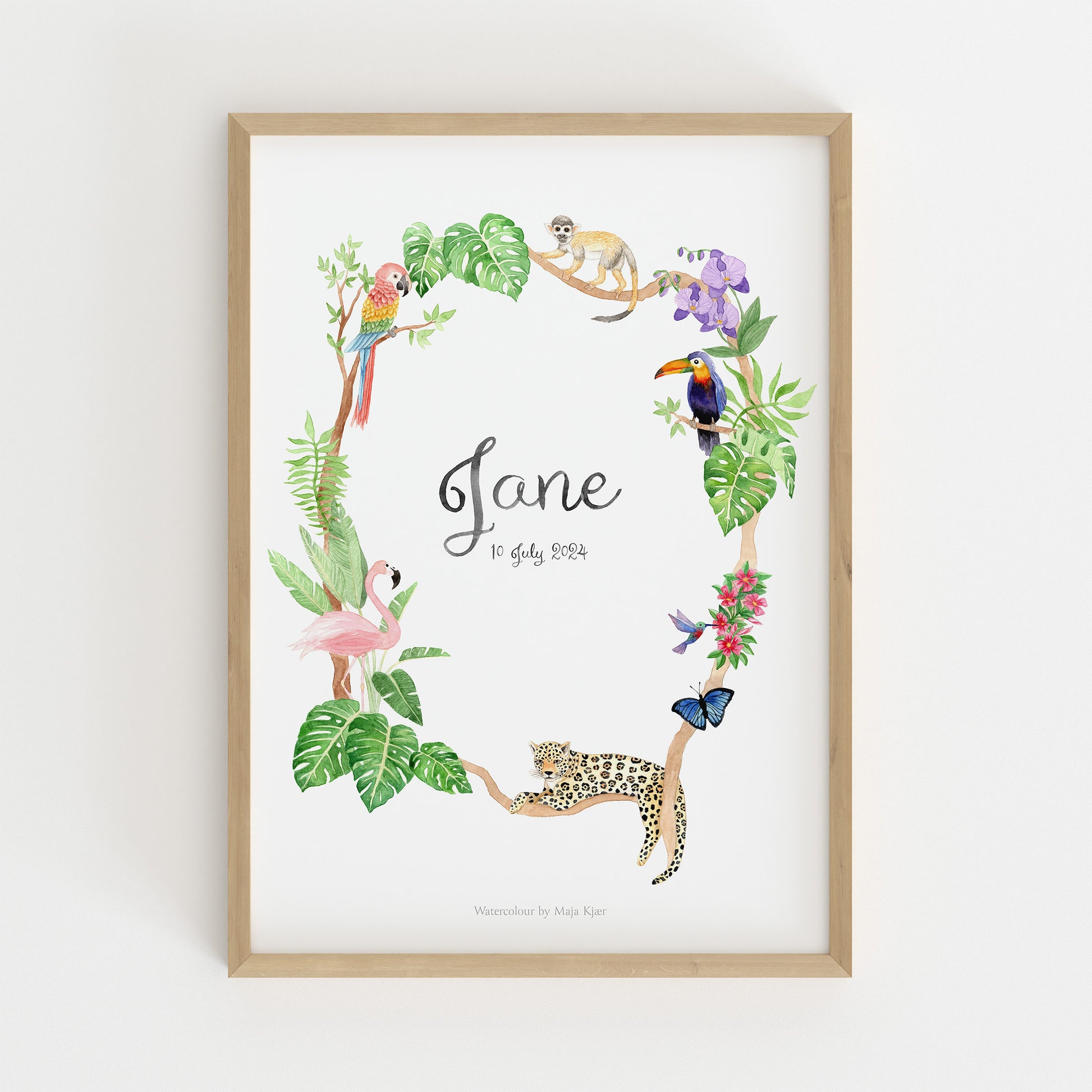 Framed baby name poster with jungle animals and leaves on a white background