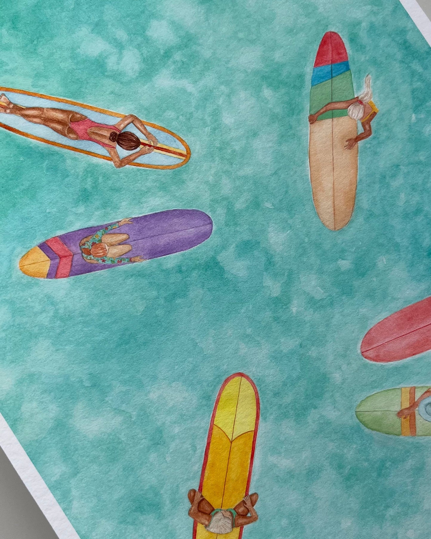 Colorful surfboards with people on a turquoise background