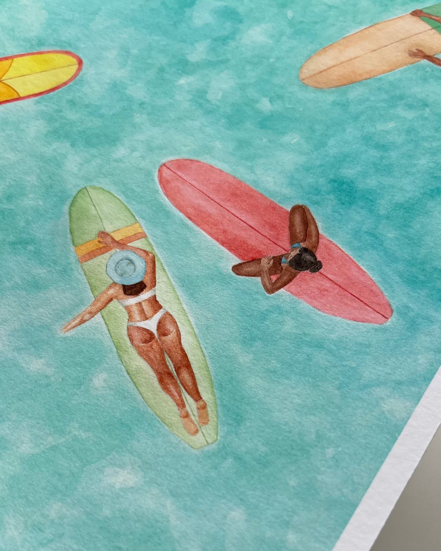 Illustration of women on surfboards in a watercolor style with a blue-green gradient background.