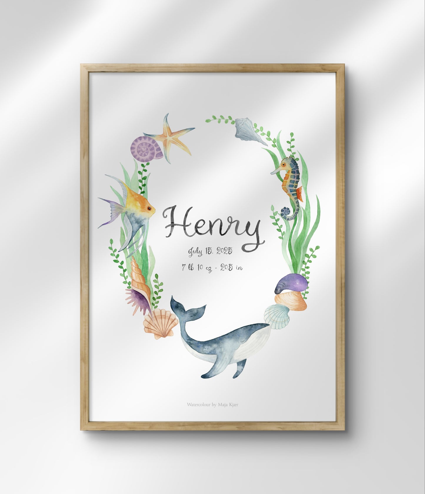 Framed artwork with a whale, sea creatures, and the name 'Henry' on a white background.