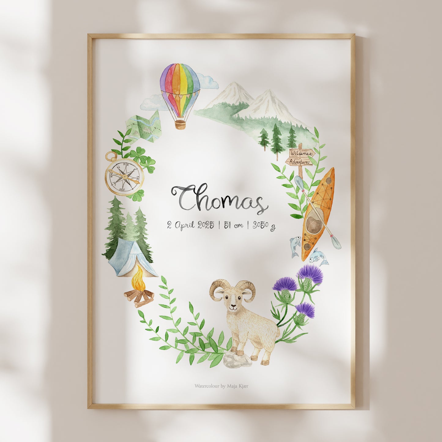 Framed custom zodiac poster with nature-themed elements and 'Thomas' text on a light background