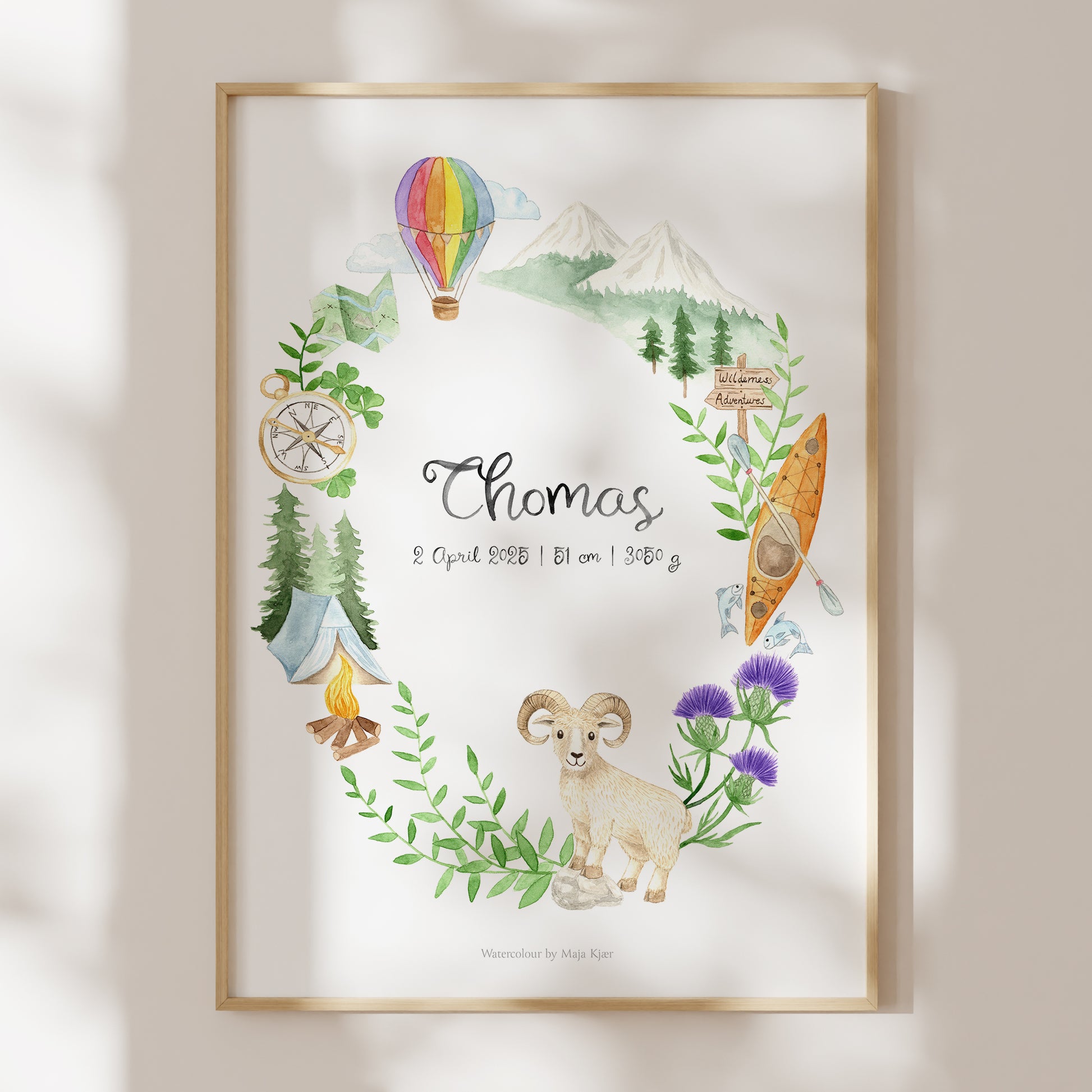 Framed custom zodiac poster with nature-themed elements and 'Thomas' text on a light background