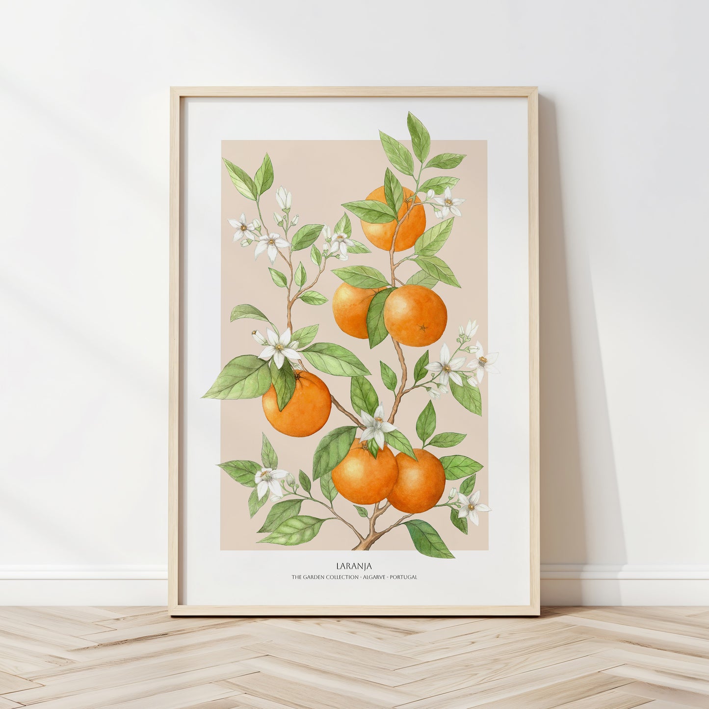 Framed artwork of oranges and leaves on a beige background