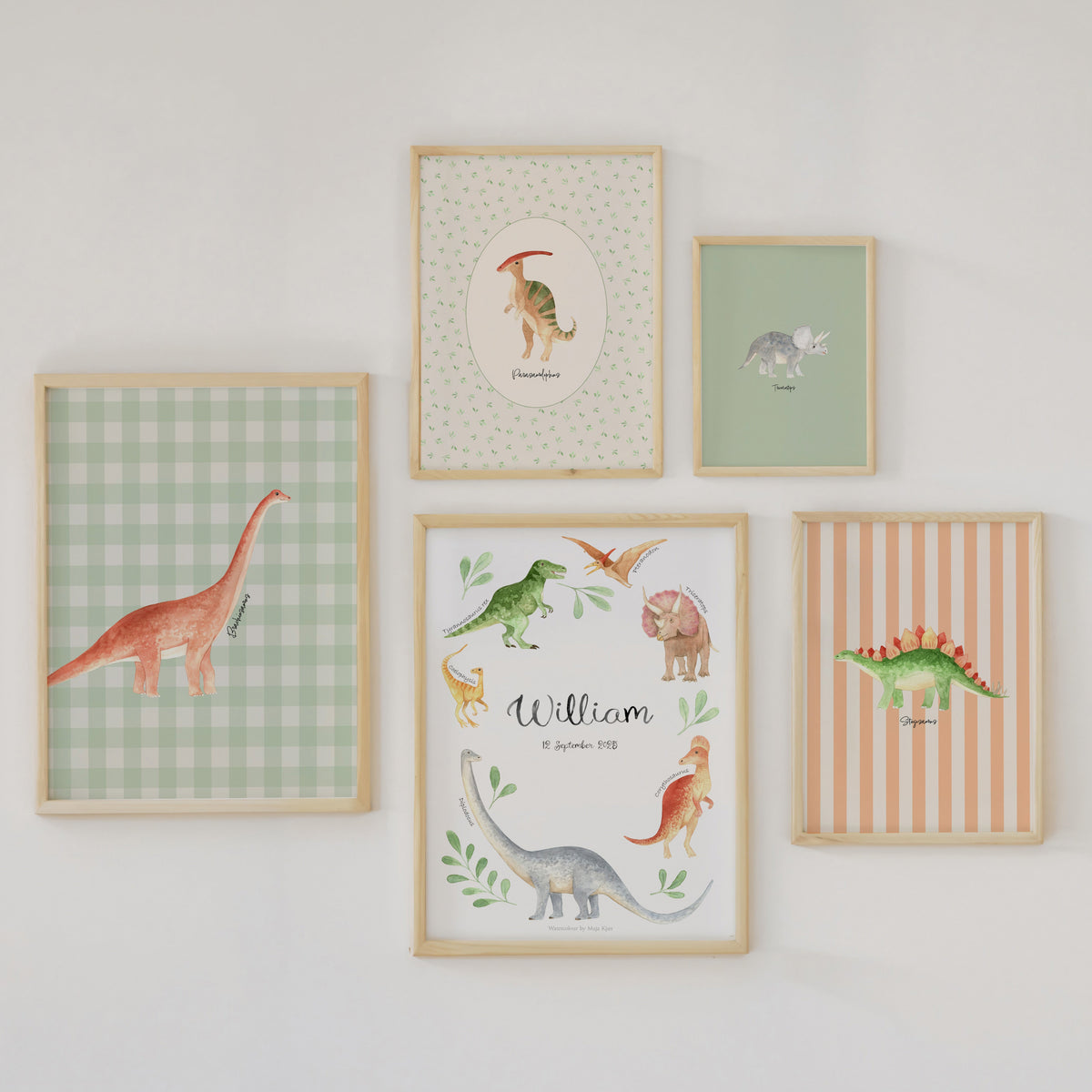Five framed dinosaur-themed nursery wall art prints arranged on a white wall. The prints feature watercolor-style dinosaurs on pastel backgrounds, including green gingham, striped, and solid colors, with one personalized print reading 'William'.