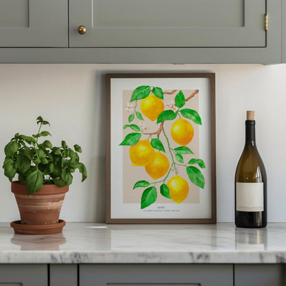 Framed artwork of lemons on a kitchen counter with a plant and wine bottle.