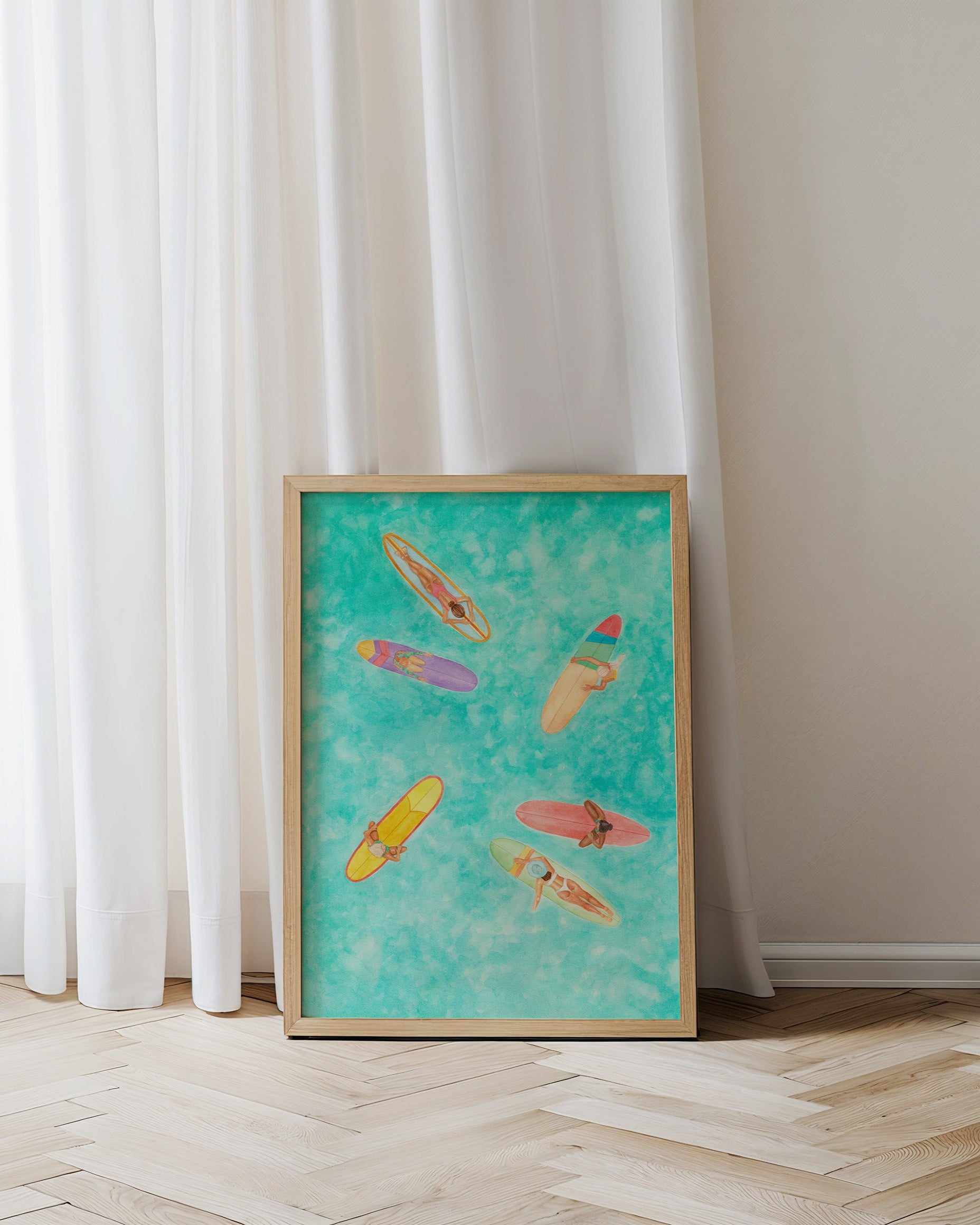 Framed artwork of colorful kayaks on a blue background against a white curtain.