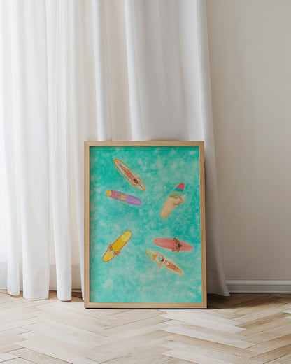 Framed artwork of colorful kayaks on a blue background against a white curtain.