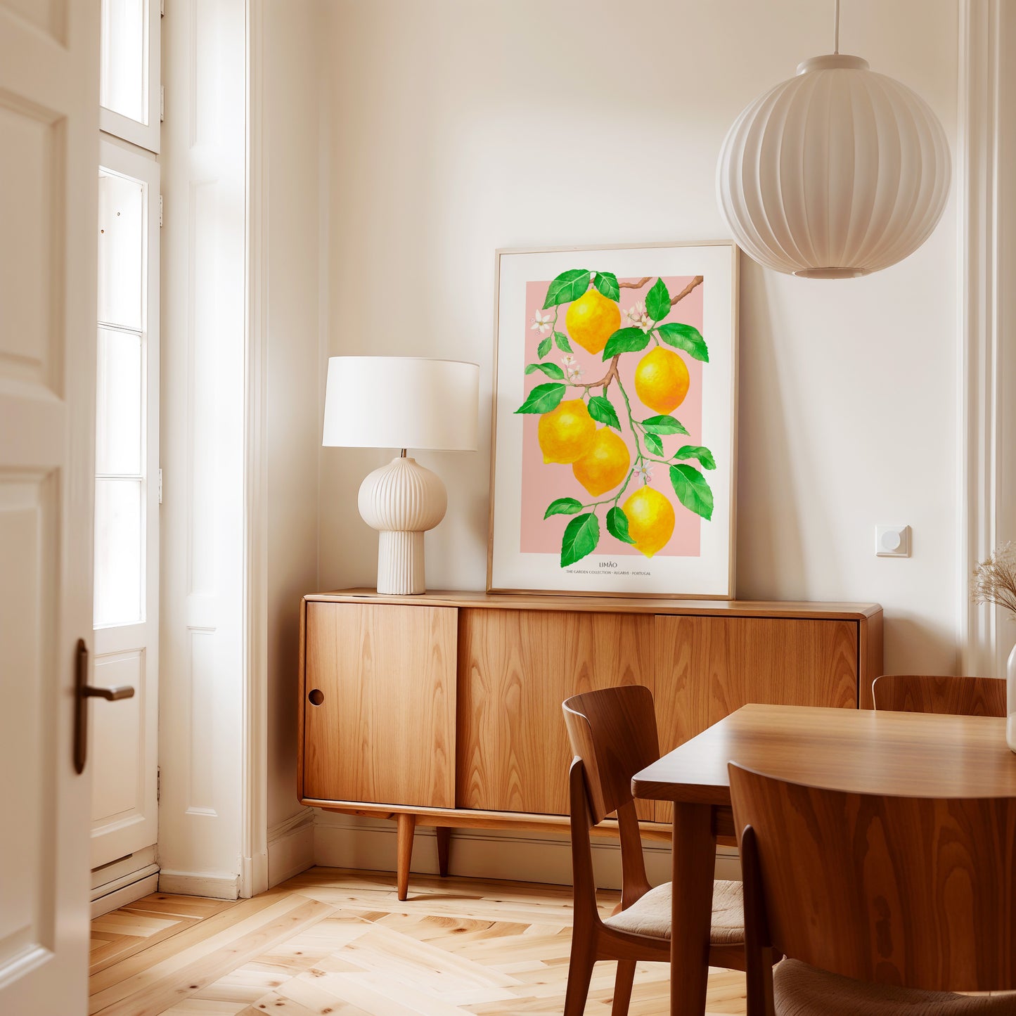 Dining room with wooden furniture, a lamp, and a lemon-themed artwork on the wall.