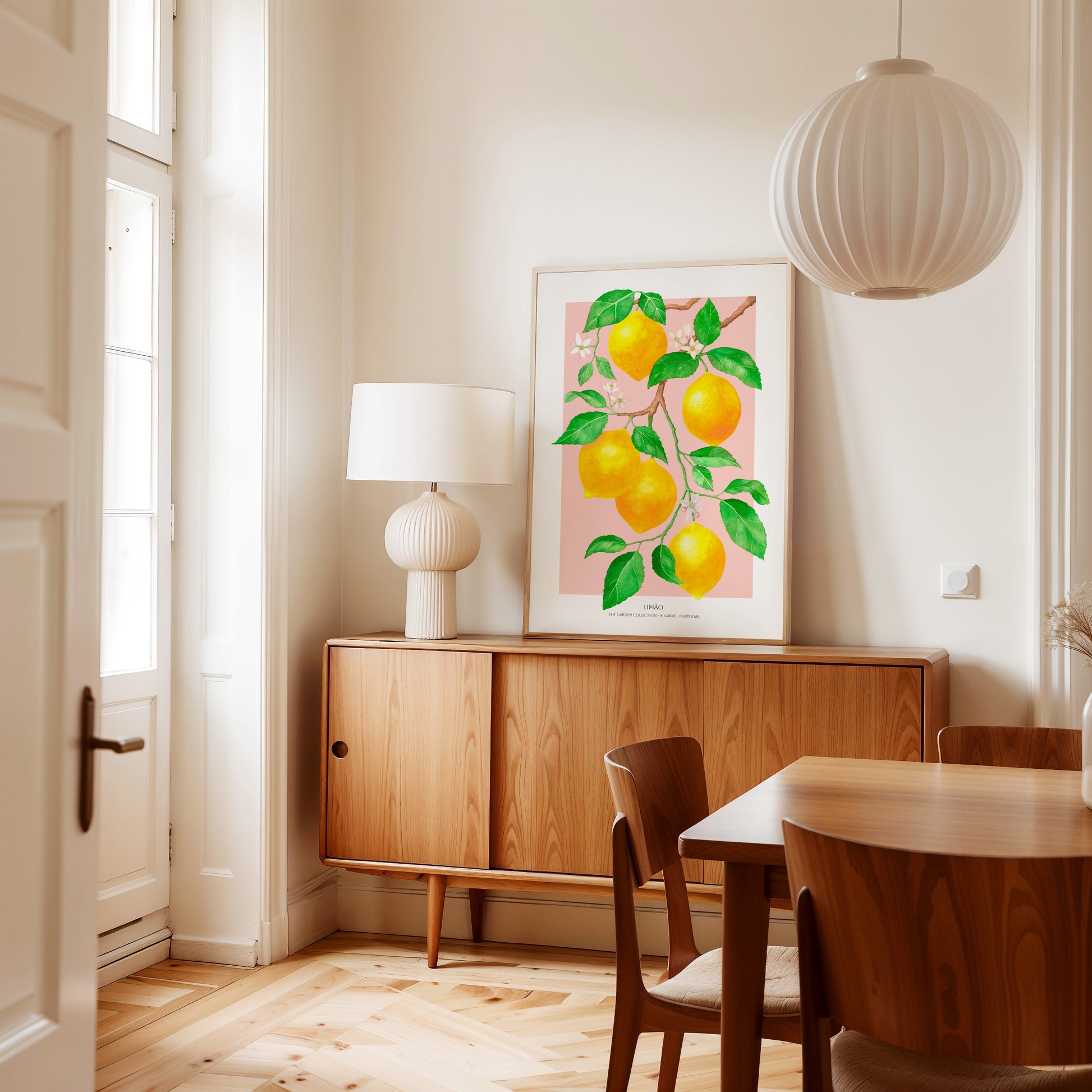 Dining room with wooden furniture, a lamp, and a lemon-themed artwork on the wall.