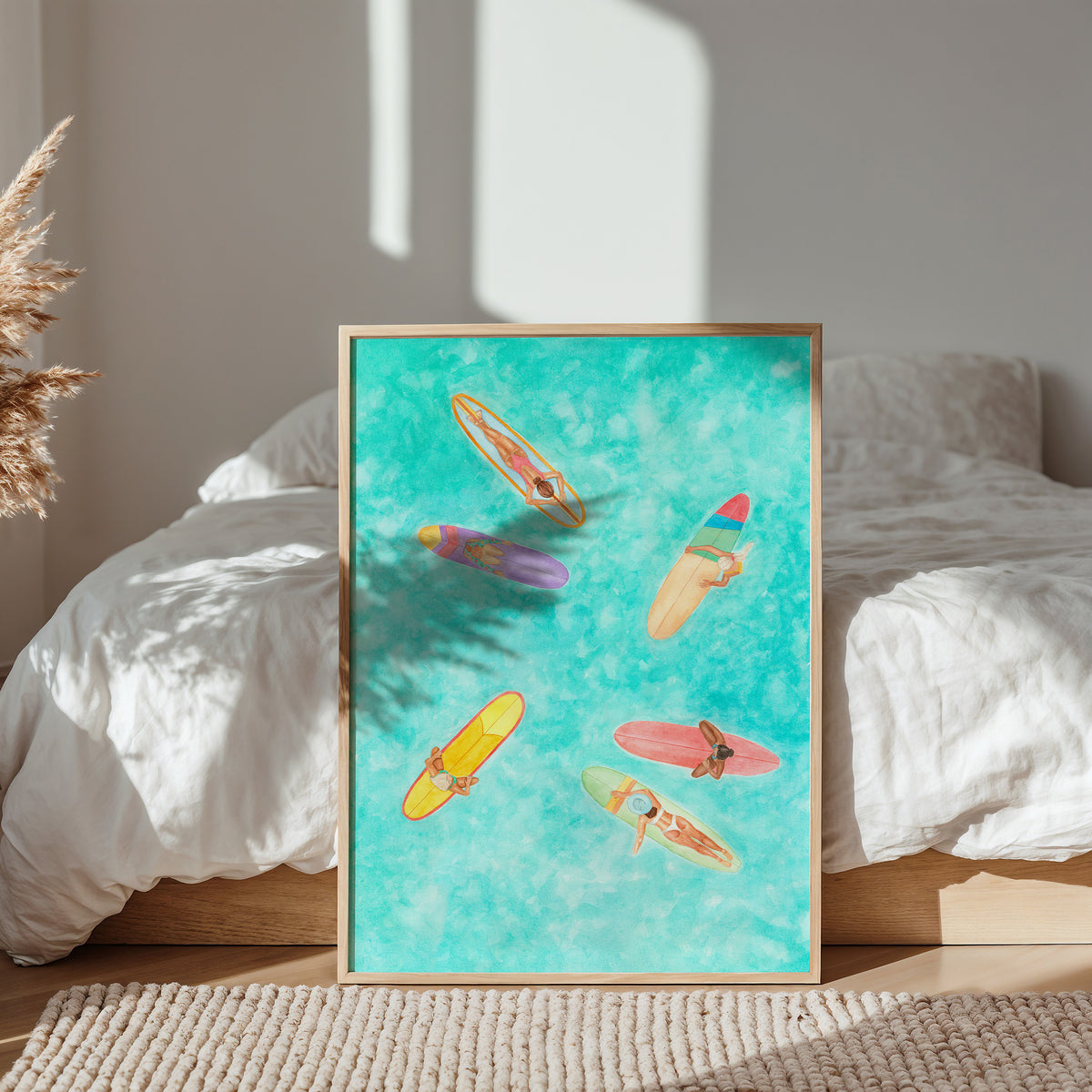 Framed artwork of colorful surfboards on a bed with natural light