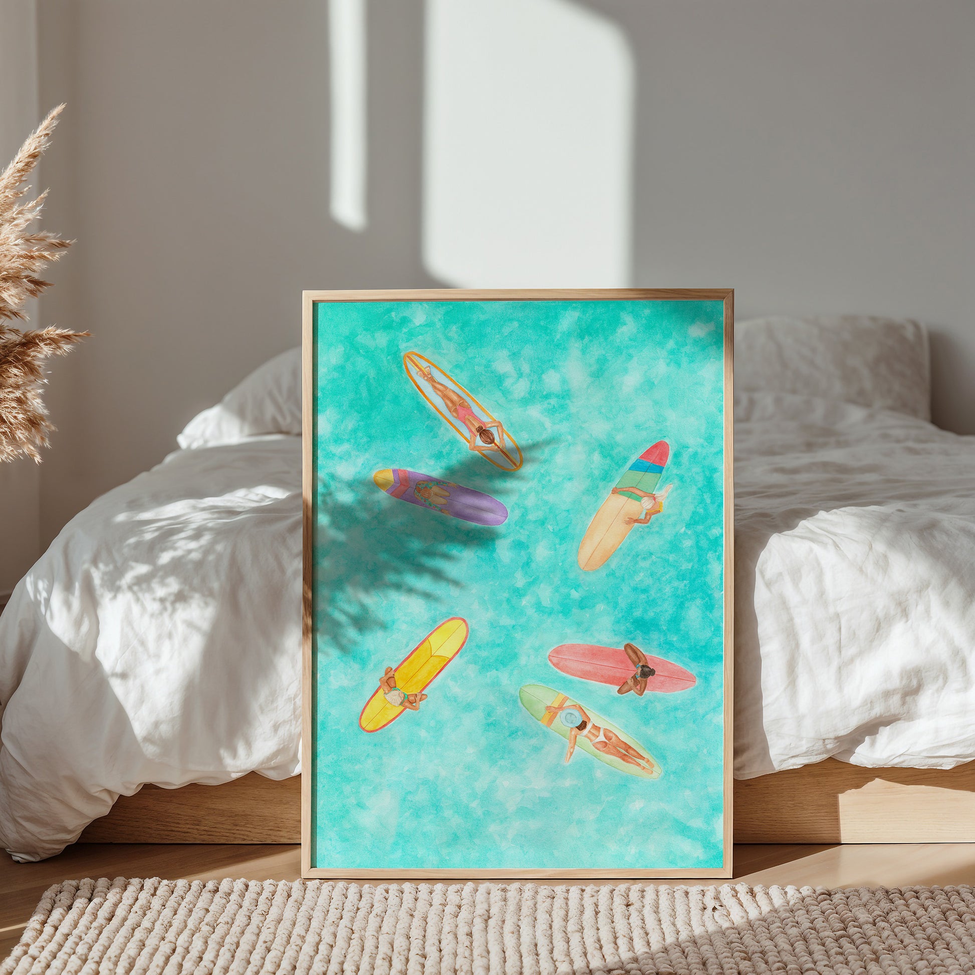 Framed artwork of colorful surfboards on a bed with natural light