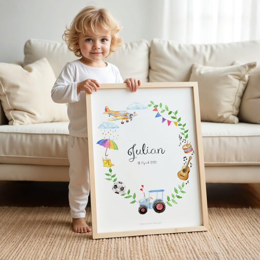 Child holding a framed name poster with illustrations and the name 'Julian' in a living room.
