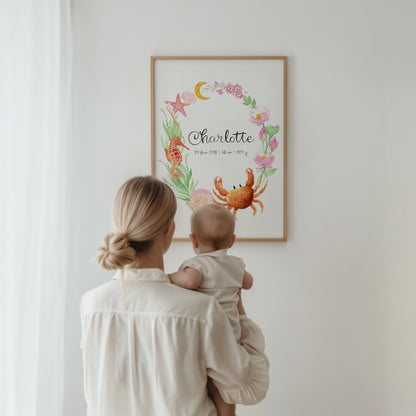 Woman holding a baby looking at a framed artwork on a wall