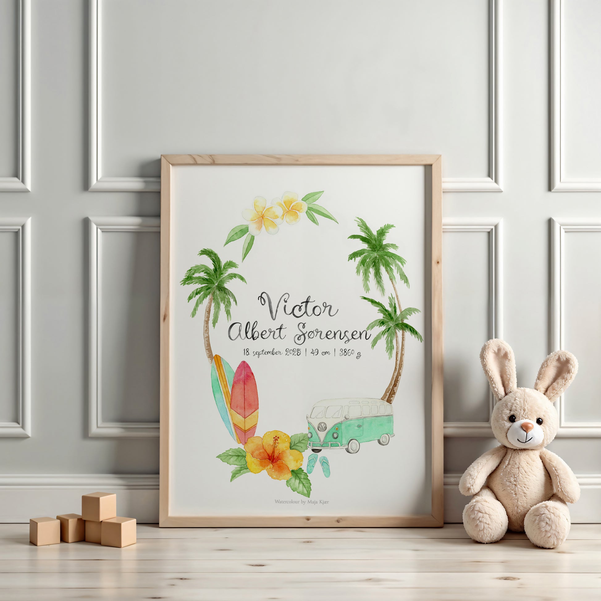 Framed artwork with palm trees, surfboard, and car design on a wall with a teddy bear and wooden blocks.