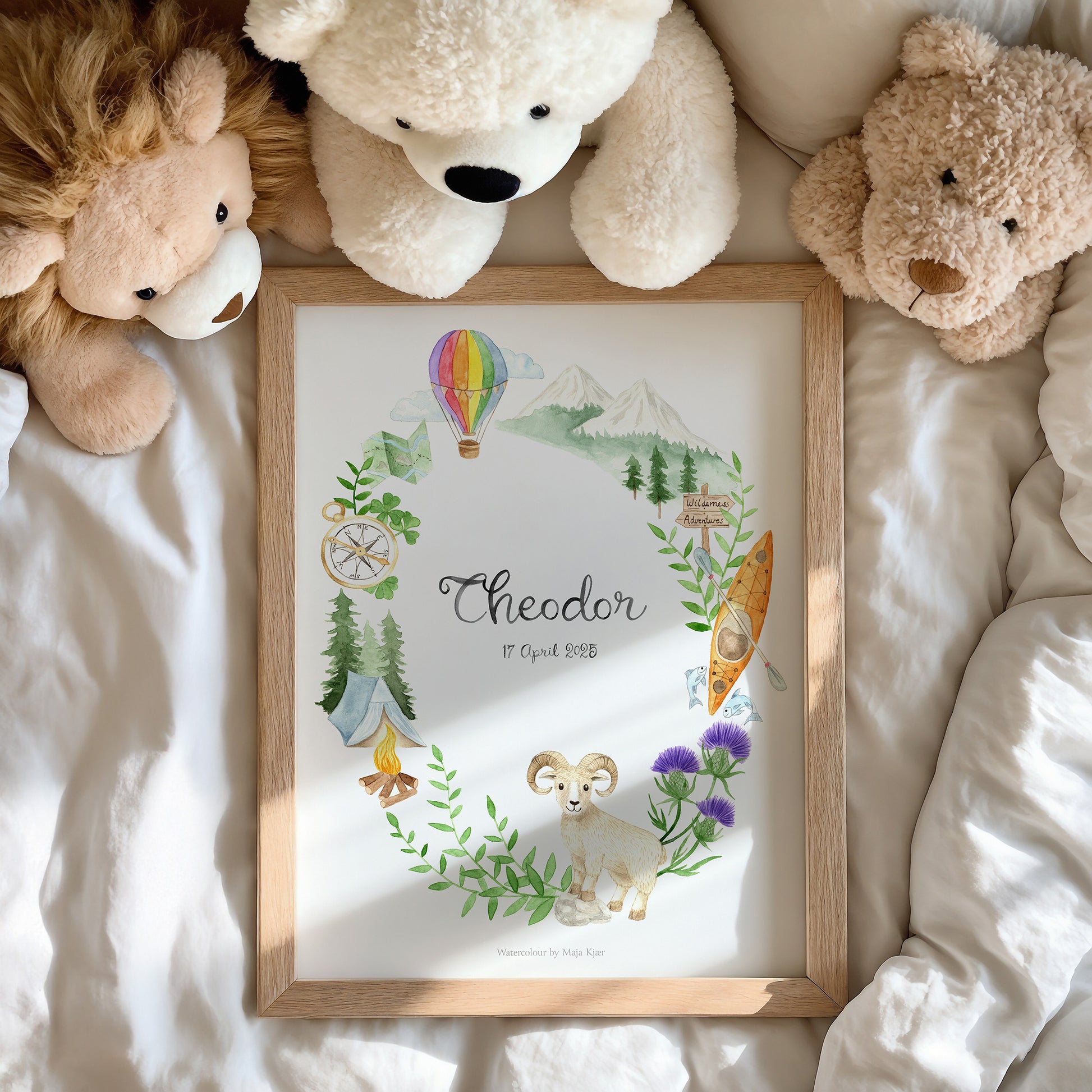 Framed artwork with illustrations and text, surrounded by teddy bears on a soft surface.