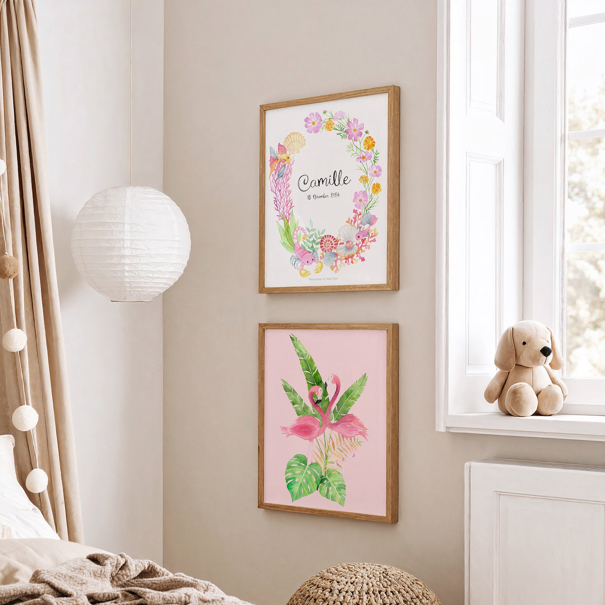 Two framed watercolour posters with personalised zodiac sign and pink flamingos in girls' nursery on a wall with a teddy bear on a windowsill.