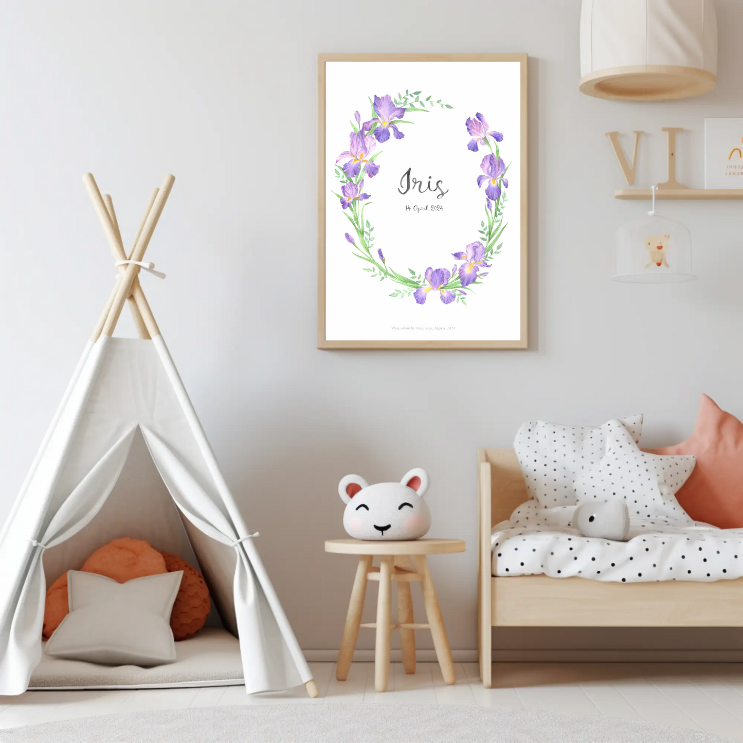 Baby girl custom name print with purple irises and green leaves in watercolour in wooden frame hanging on the wall of a nursery with a Scandinavian feel
